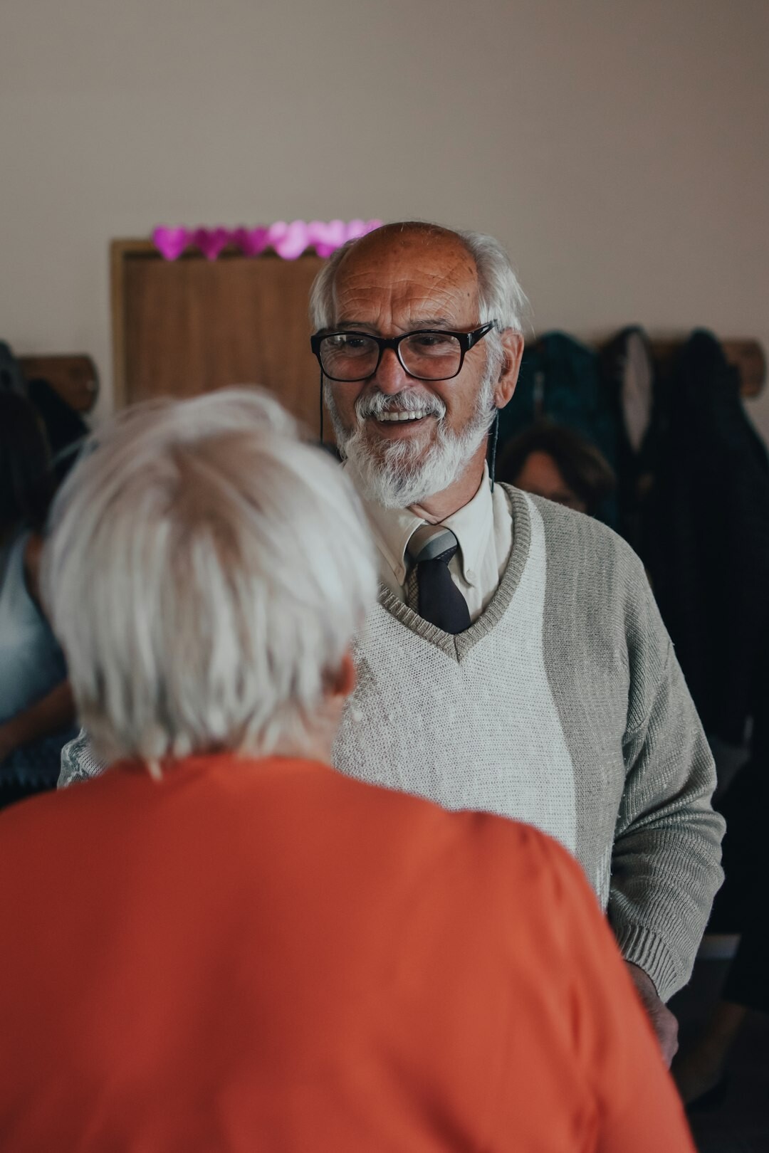 Seniors chatting and enjoying coffee together in a bright community room