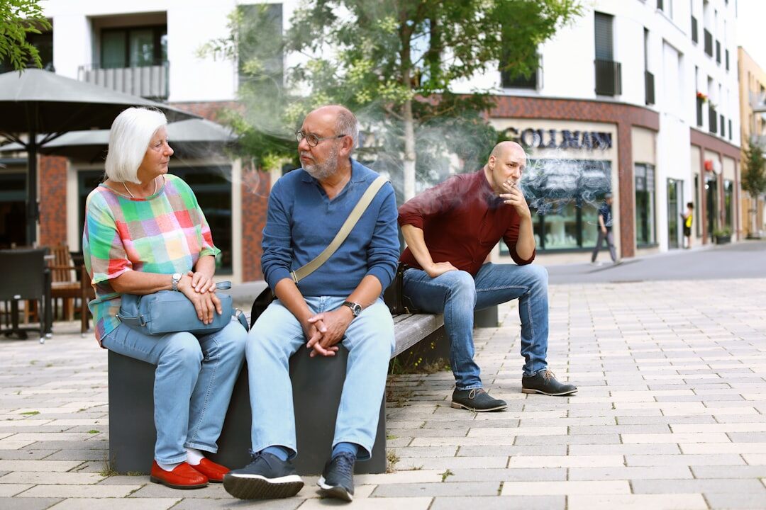 Group of happy senior friends laughing together outdoors in a park