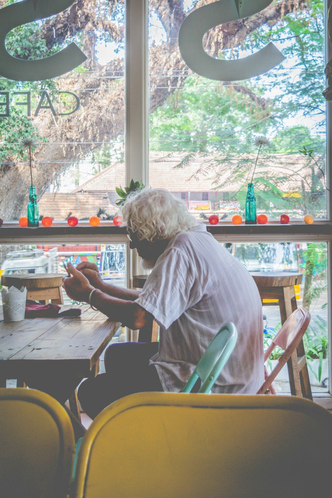 Senior citizens painting and doing crafts together at a table